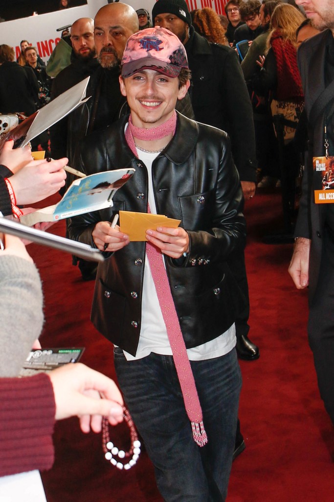 Timothee Chalamet signs autographs at a screening of "A Complete Unknown" in Paris.